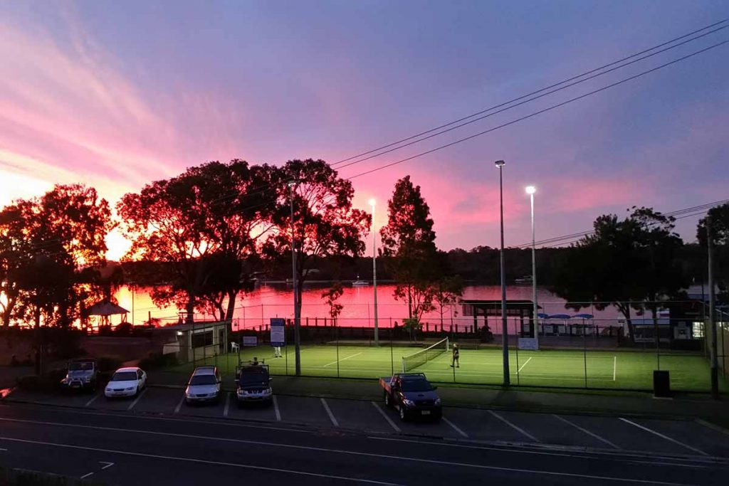 Noosa Foreshore - playing tennis as the sun sets over the Noosa River